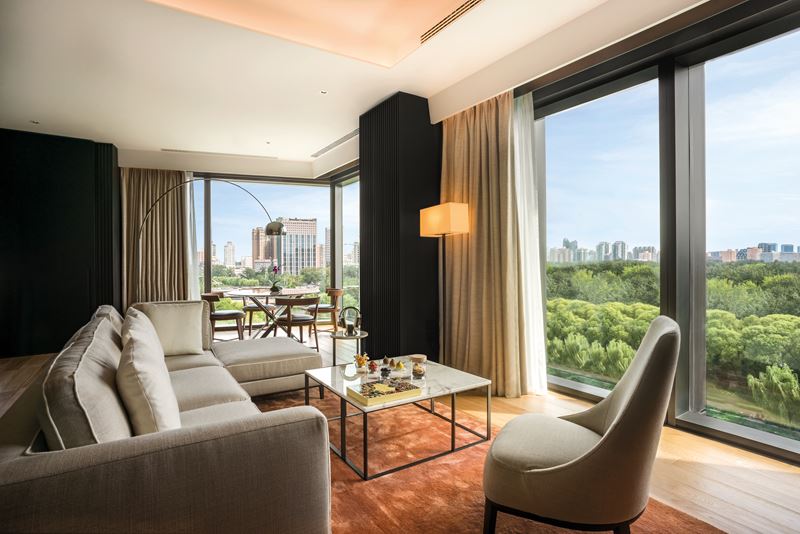 Bulgari Hotel Beijing - дизайн интерьера гостиной с панорамными видами из окна